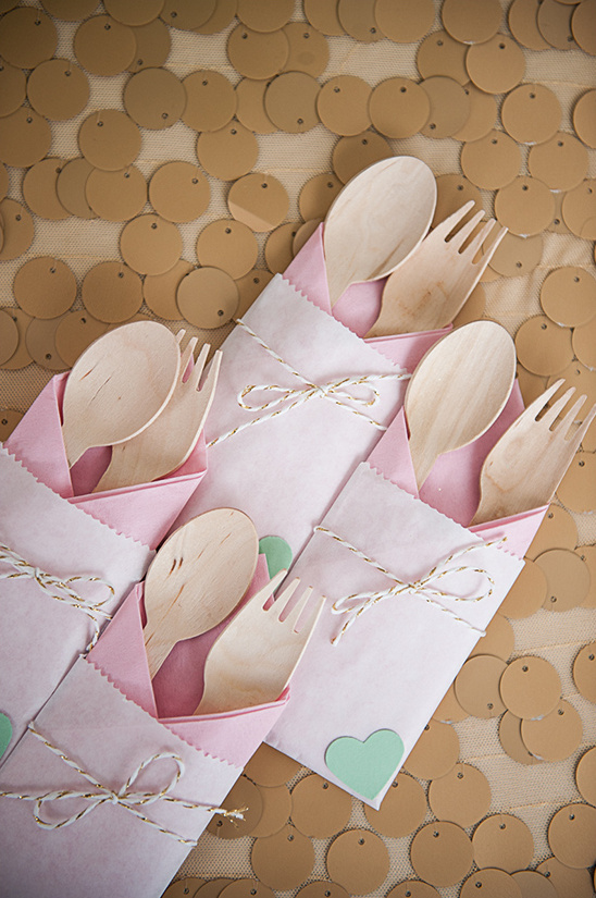 Wooden spoons and forks in pink paper envelopes, event decor