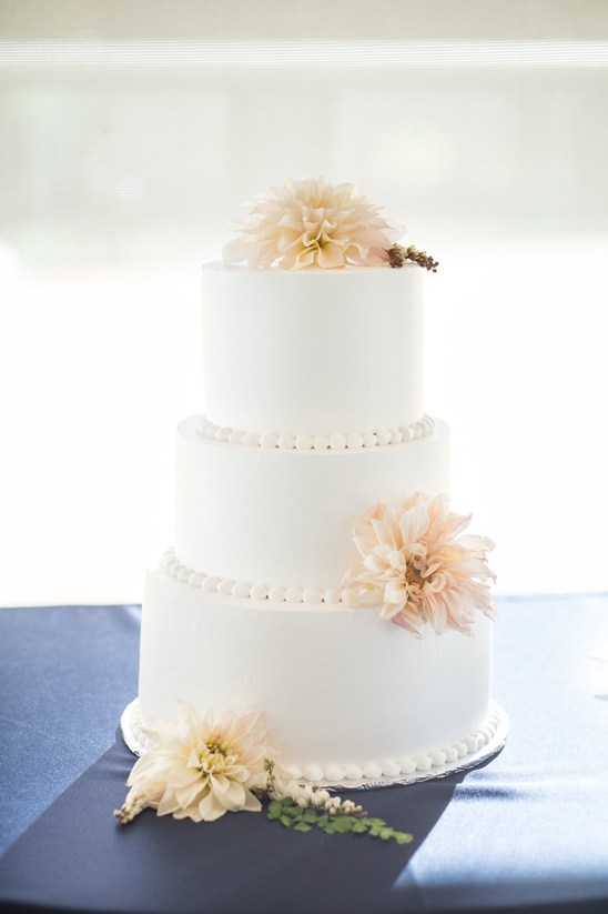 clean dahlia topped wedding cake @weddingchicks