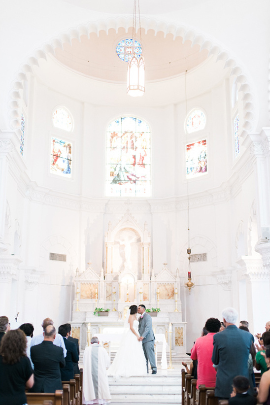 Bride and groom share a kiss in a beautiful church wedding