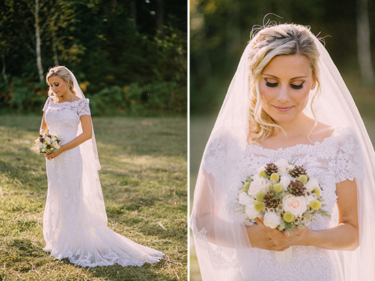 Beautiful bride in lace wedding dress holding a floral bouquet