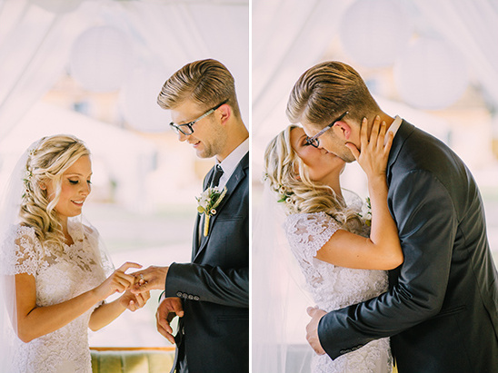 Bride and groom exchange rings during a wedding ceremony, then kiss