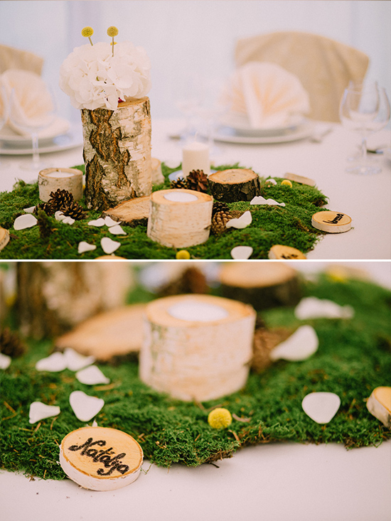 Rustic wedding table centerpiece with moss and wooden accents