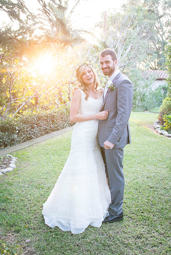 Happy bride and groom smiling outdoors on their wedding day