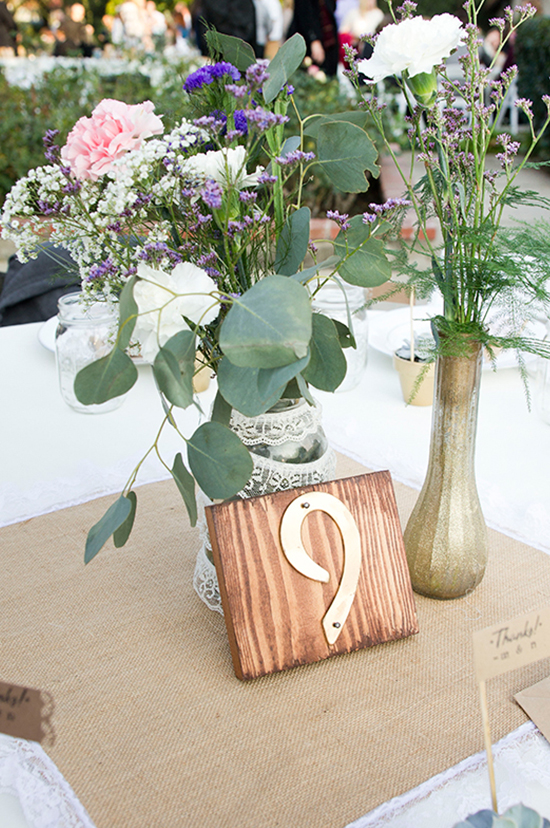 Elegant wedding table centerpiece with flowers and table number nine