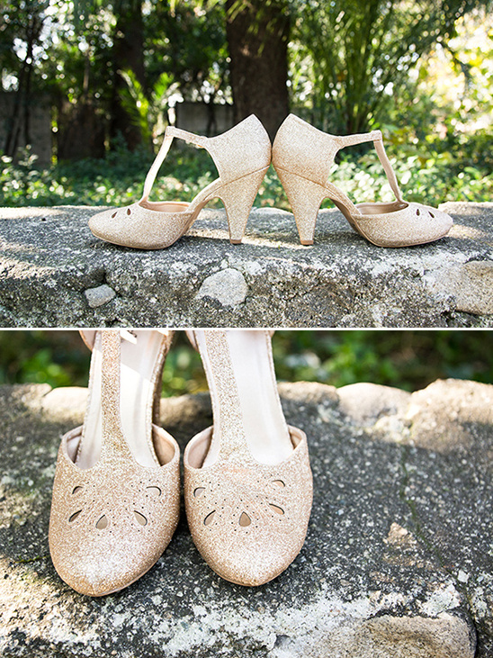 Elegant sparkling gold wedding shoes displayed outdoors