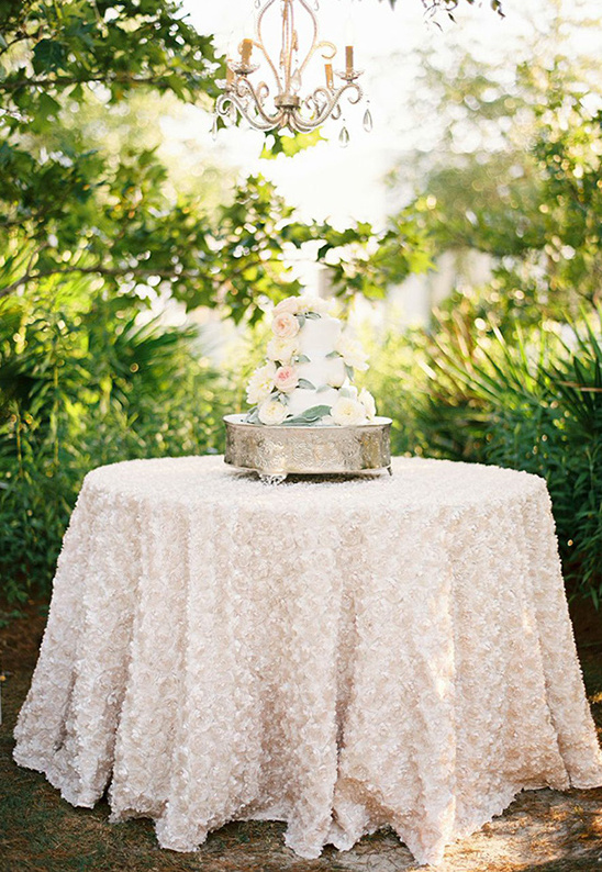 beautiful flower covered wedding cake @weddingchicks