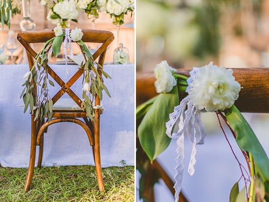 Wooden chair decorated with white flowers and greenery for a wedding