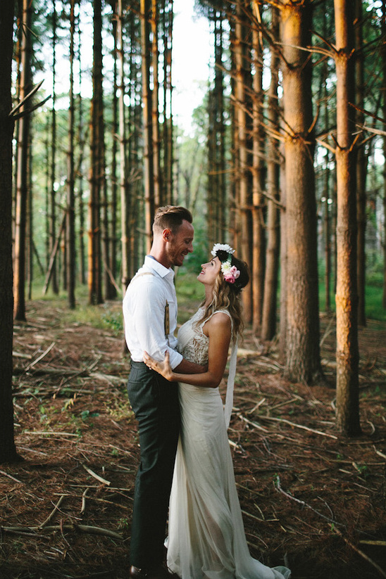 Bride and groom embracing in a forest wedding scene