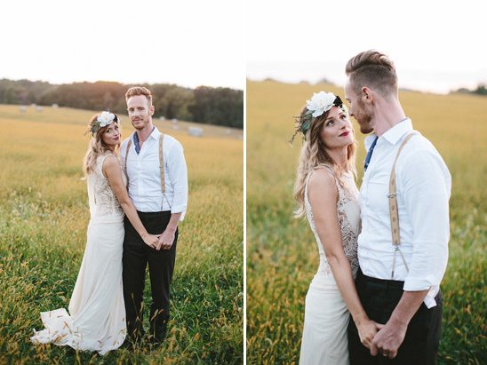 Boho chic wedding couple in grassy field at sunset