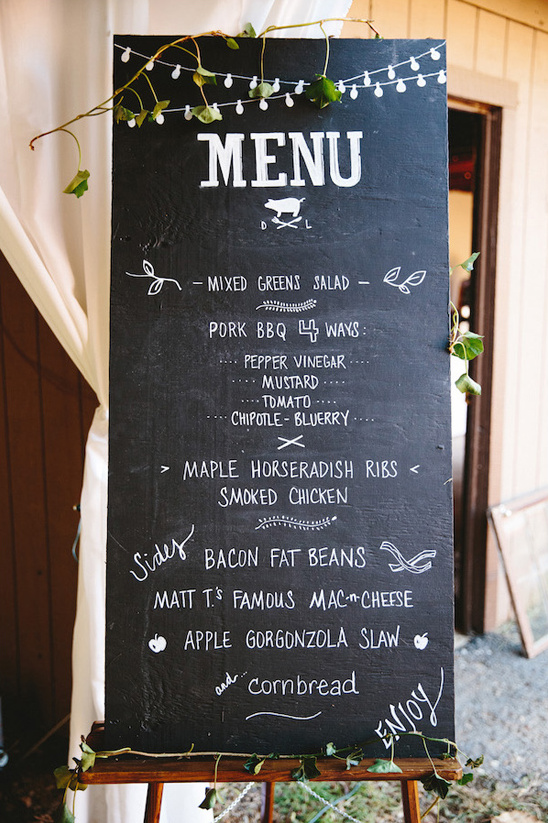 Rustic menu board at a wedding with delicious food options