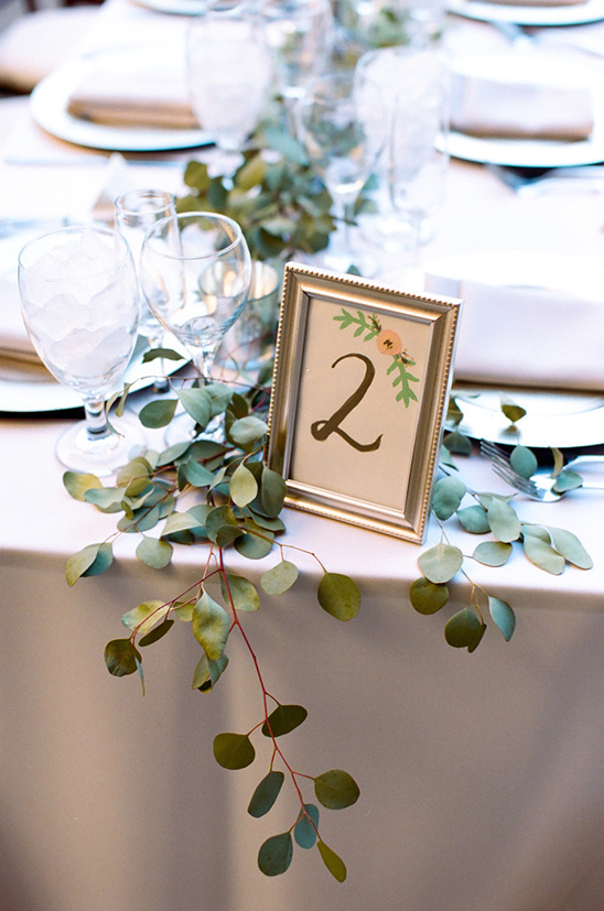 Elegant wedding table setting with table number 2 and eucalyptus decor