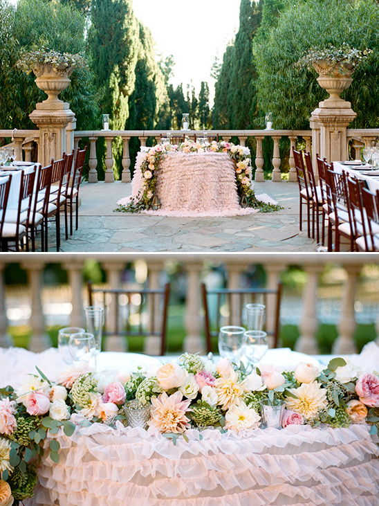 Elegant outdoor wedding table with floral centerpiece and ruffled skirt