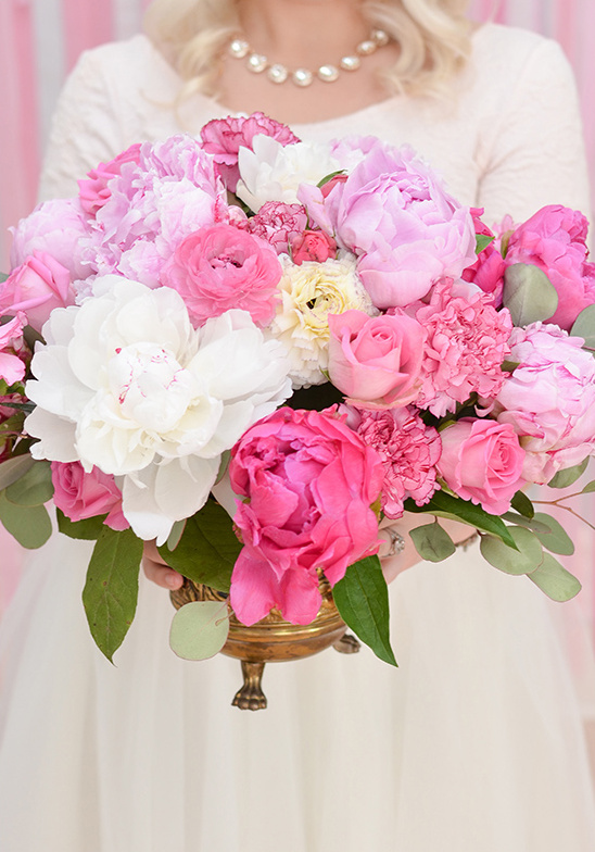 Elegant bouquet of pink peonies and roses in a gold vase