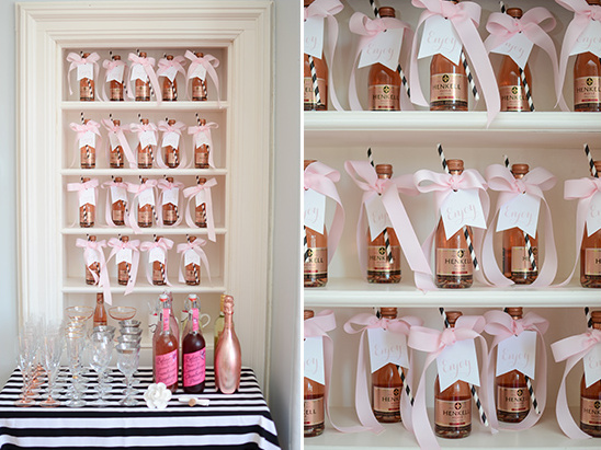 Mini champagne bottles with pink bows for a celebration event