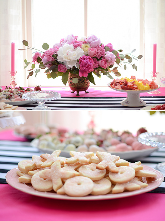 Elegant dessert table with flowers, cookies and fruits