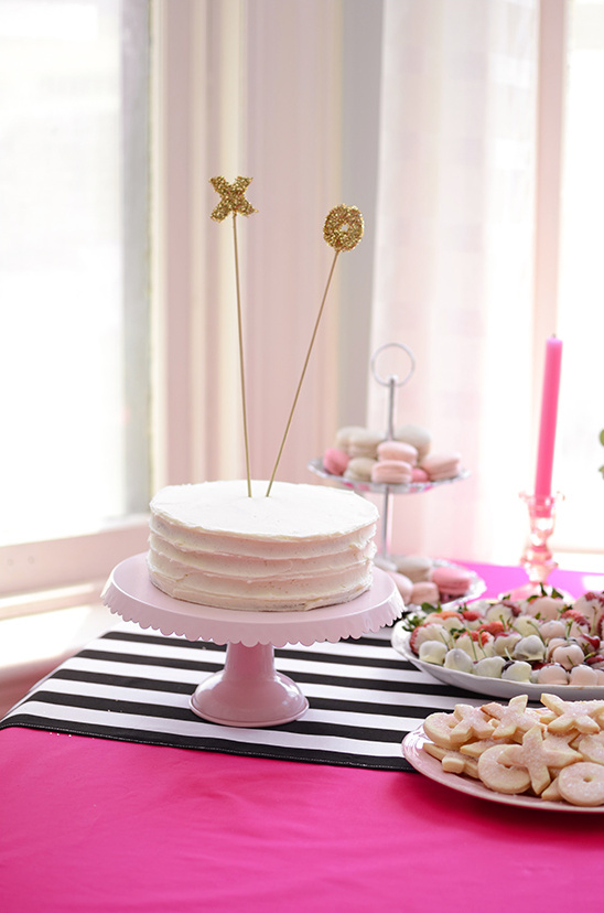 A delicious cake with XO toppers on a beautifully decorated table