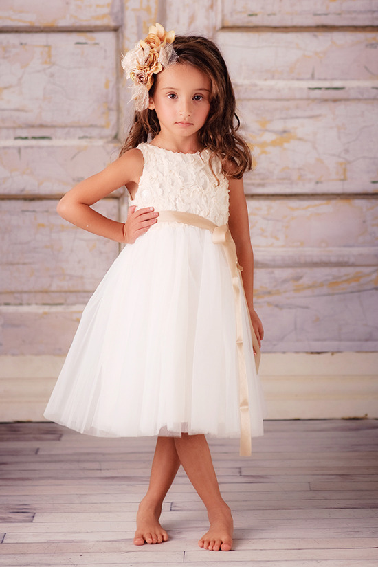 Young girl in white flower dress with flower hair accessory