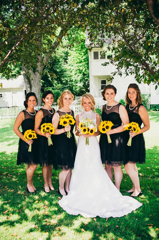 black dress bridesmaids with sunflower bouquets @weddingchicks