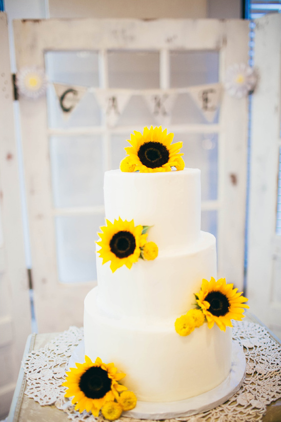 sunflower topped wedding cake @weddingchicks