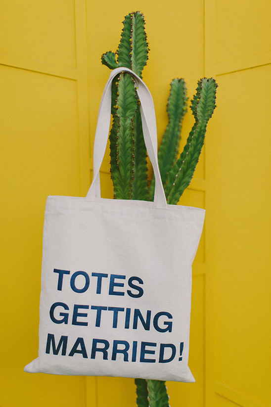 Totes Getting Married bag on cactus against yellow wall