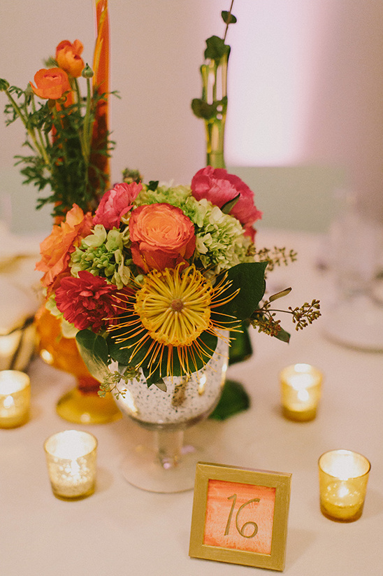 Floral centerpiece with candles and table number 16