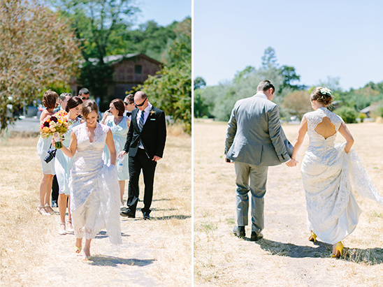Bride and Groom walk holding hands during a sunny outdoor wedding