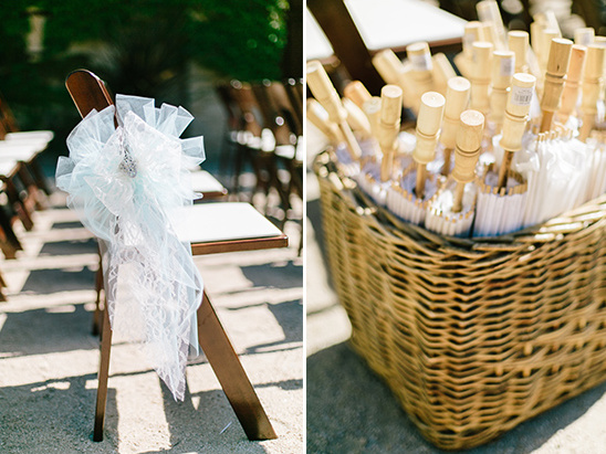 Wedding chairs with lace and parasols in a wicker basket