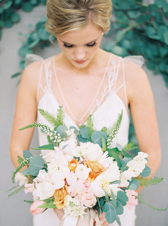 Elegant bride holding a beautiful wedding bouquet of flowers