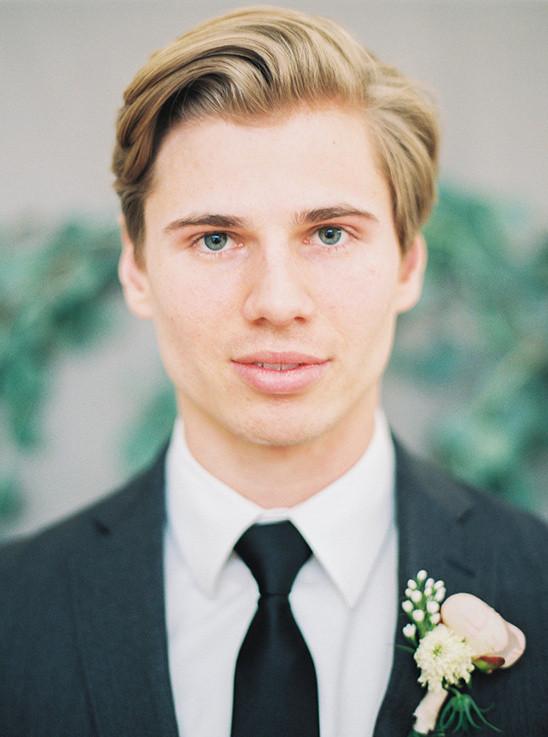 Handsome blond groom in a suit ready for his wedding