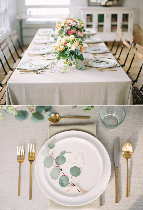 Elegant table setting with floral centerpiece and gold cutlery