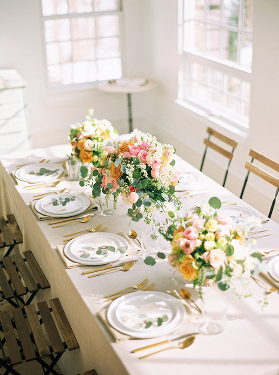 Elegant table setting with flowers and gold cutlery ready to celebrate