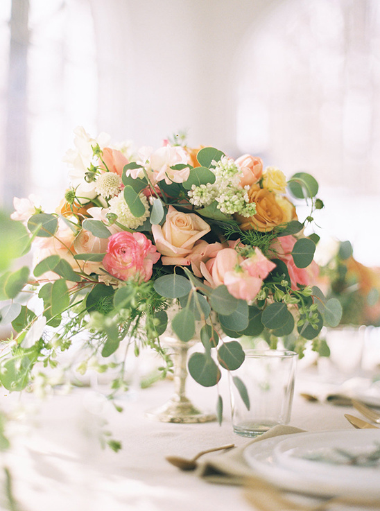 Elegant floral centerpiece with roses and greenery for a table