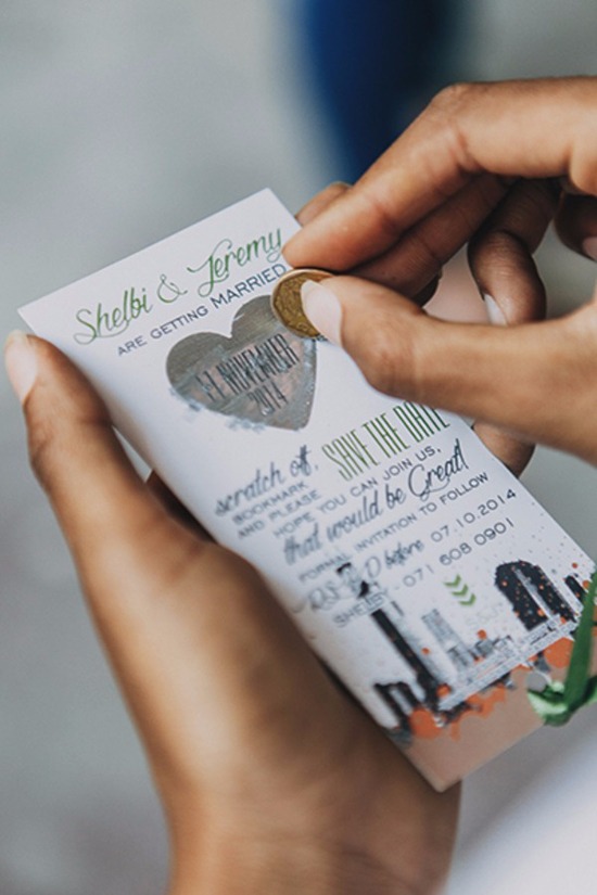 Person scratching a save-the-date scratch card with a coin