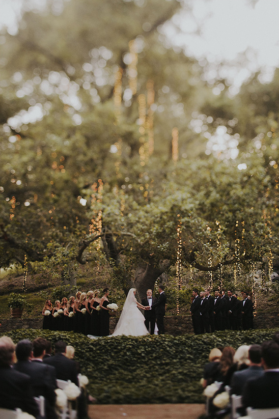 Outdoor wedding ceremony with lights in a beautiful garden