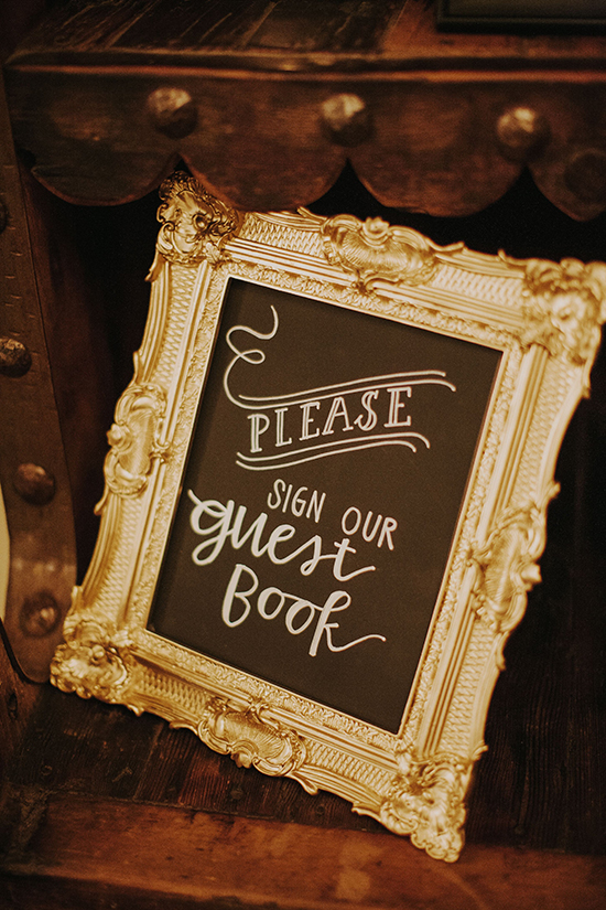 Wedding guest book sign with ornate gold frame, calligraphy