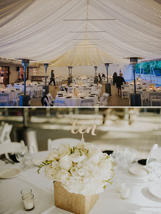 Wedding reception tent with elegant table settings and floral decor