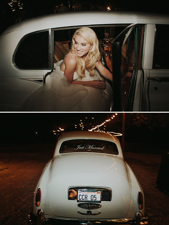 Bride exiting wedding car in a joyful moment under the lights