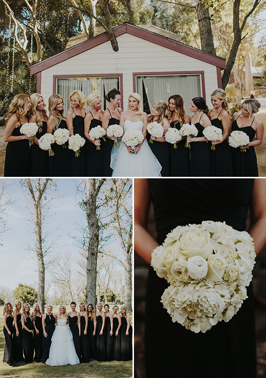 Bridesmaids in black dresses with bouquets at an outdoor wedding