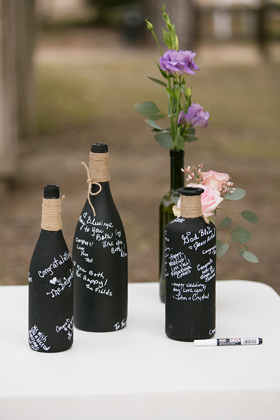Wedding wine bottles with notes and flowers decoration