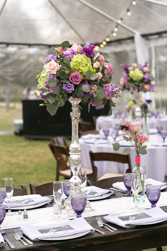 Wedding table setting with floral centerpiece and purple details