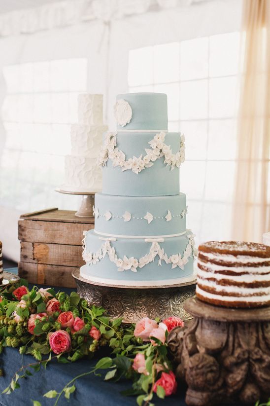 Elegant tiered wedding cake with floral details on display