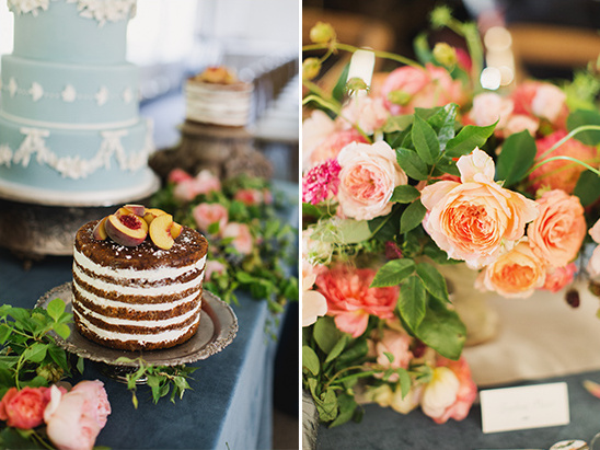 A beautiful wedding cake with peach slices next to floral decor