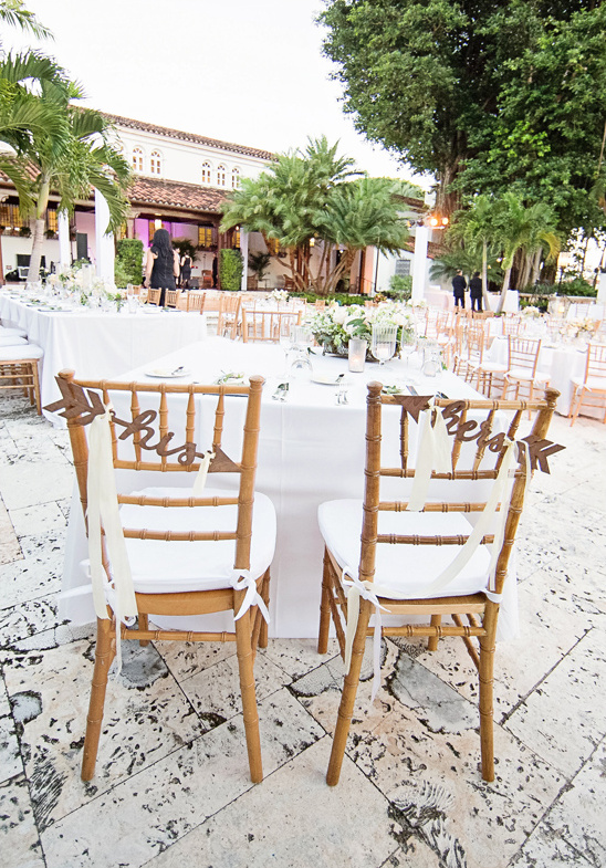 Elegant wedding reception with his and hers chair decorations