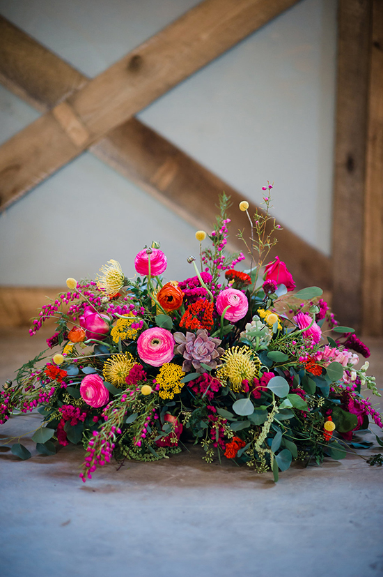 Bright and vibrant floral centerpiece with a wooden background