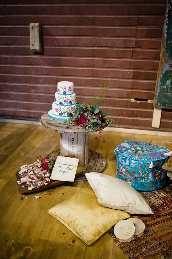 Wedding cake with floral decorations on rustic wooden table