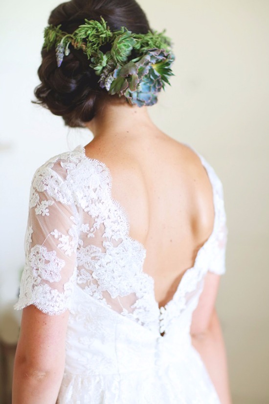 Bride in lace dress with flower crown hairstyle detail