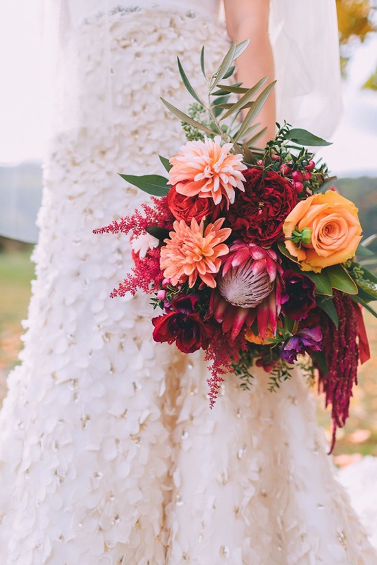 Bride holding vibrant colorful wedding bouquet close up