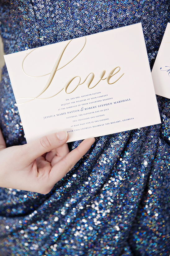 Love themed wedding invitation on blue sequin dress