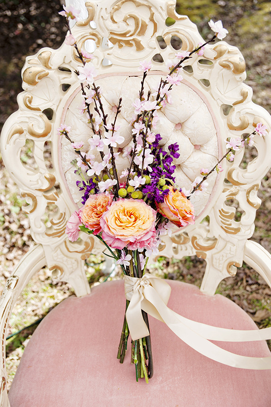 Floral bouquet on antique chair soft peach and purple tones