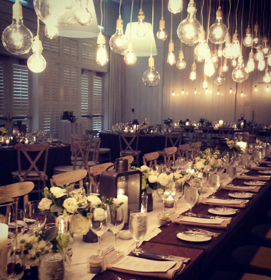 Elegant wedding reception table setting with string lights decor